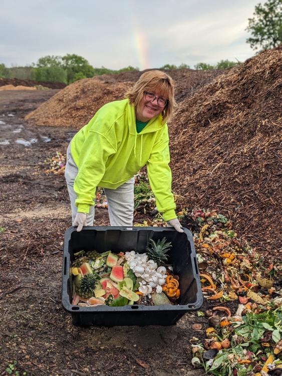 Jennifer Sandor dumping food scraps at the Neighborhood Food Solutions Farm